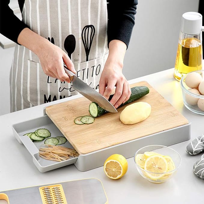 A wooden cutting board with a removable base tray, ideal for efficient food prep and easy transfer of chopped ingredients.