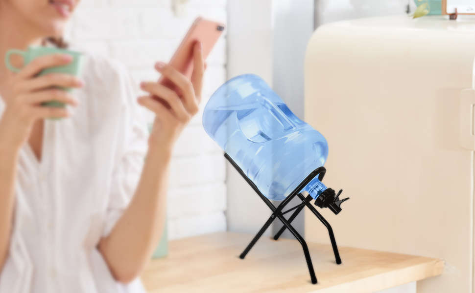 Image of a large gallon water bottle with a jug drink dispenser, placed on a foldable cradle stand. The dispenser features an easy-pour spout, and the cradle is designed for convenient storage and portability. The setup is ideal for home or office use, ensuring easy access to water throughout the day.